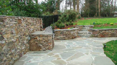 Stone patio built-in grill and retaining wall